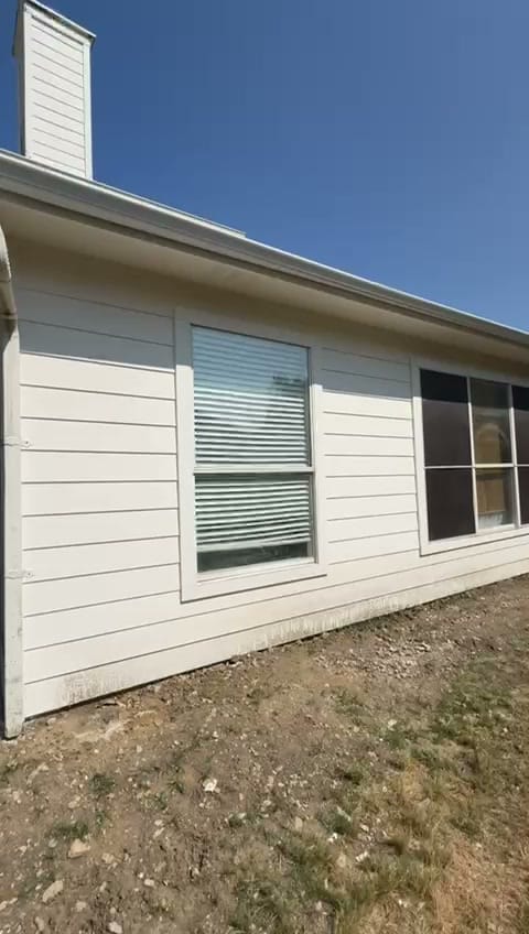 Finished one-story room addition with new siding and windows on a Fort Worth home