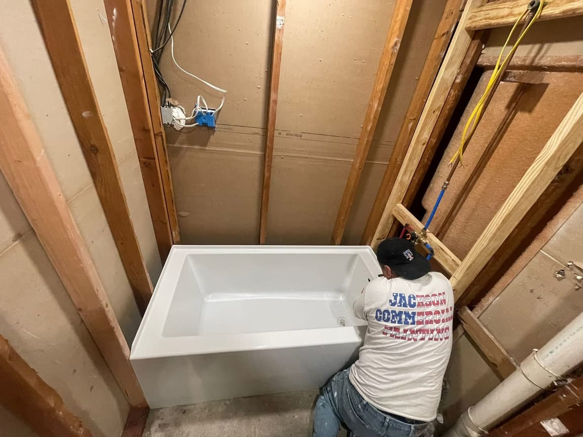 Bathroom tub and shower remodel with white subway tile and matte black fixtures