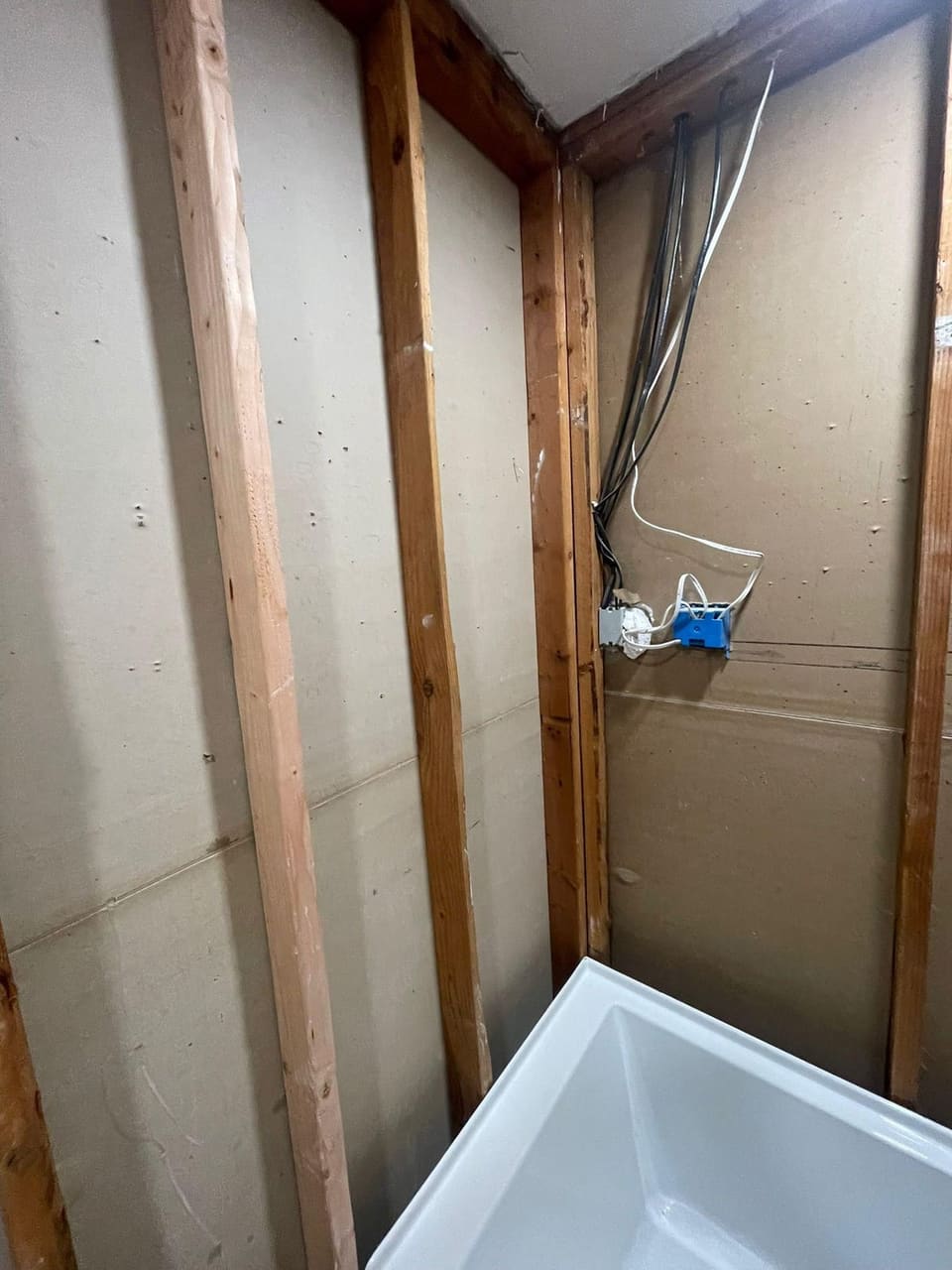 Bathroom tub and shower remodel with white subway tile and matte black fixtures