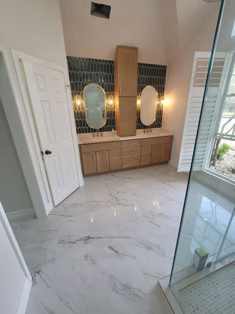 Luxury remodeled bathroom with freestanding tub and double vanity